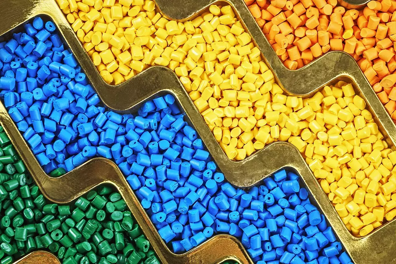 Colored polymer granules used in artificial turf manufacturing, highlighting material composition for high-performance synthetic grass systems Colored polymer granules used in artificial turf manufacturing, highlighting material composition for high-performance synthetic grass systems