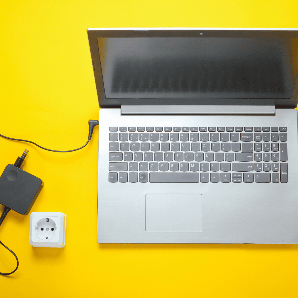 "Black laptop charger with a compact power adapter and a durable cable, featuring a standard plug for wall outlets and a connector for charging laptops efficiently." "Black laptop charger with a compact power adapter and a durable cable, featuring a standard plug for wall outlets and a connector for charging laptops efficiently."