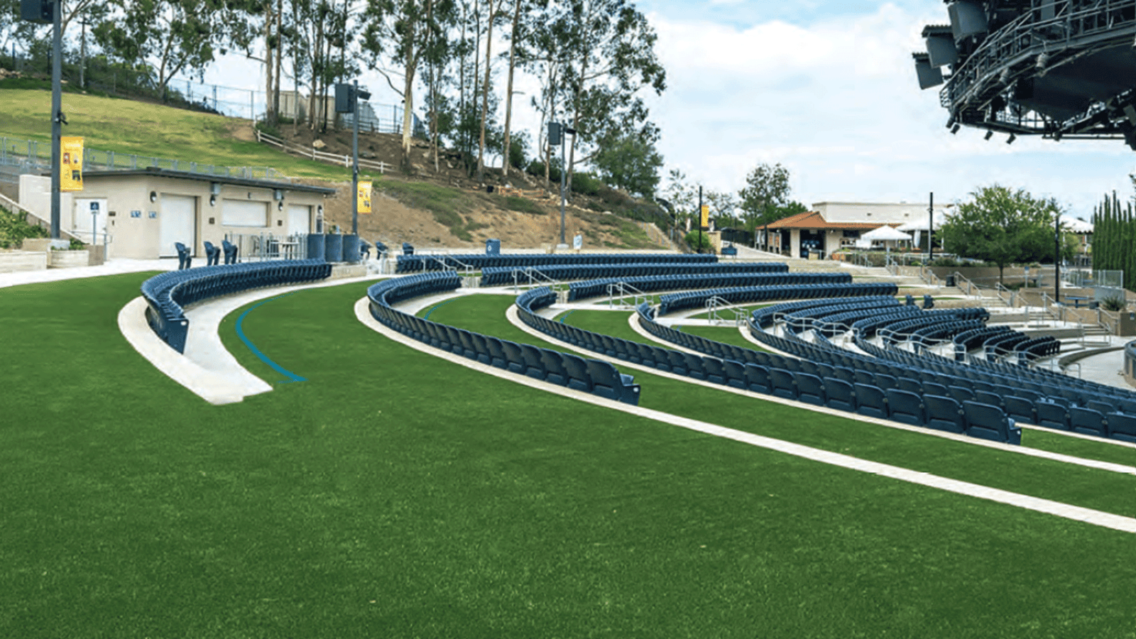 Outdoor stadium seating with artificial turf pathways, showcasing durable synthetic grass for high-traffic sports and landscaping areas Outdoor stadium seating with artificial turf pathways, showcasing durable synthetic grass for high-traffic sports and landscaping areas