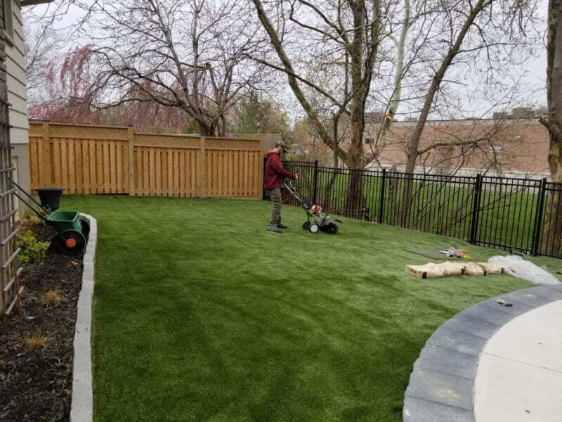 Home garden landscaping grass being maintained with lawn equipment, showing clean, even synthetic grass surface for residential outdoor use Home garden landscaping grass being maintained with lawn equipment, showing clean, even synthetic grass surface for residential outdoor use