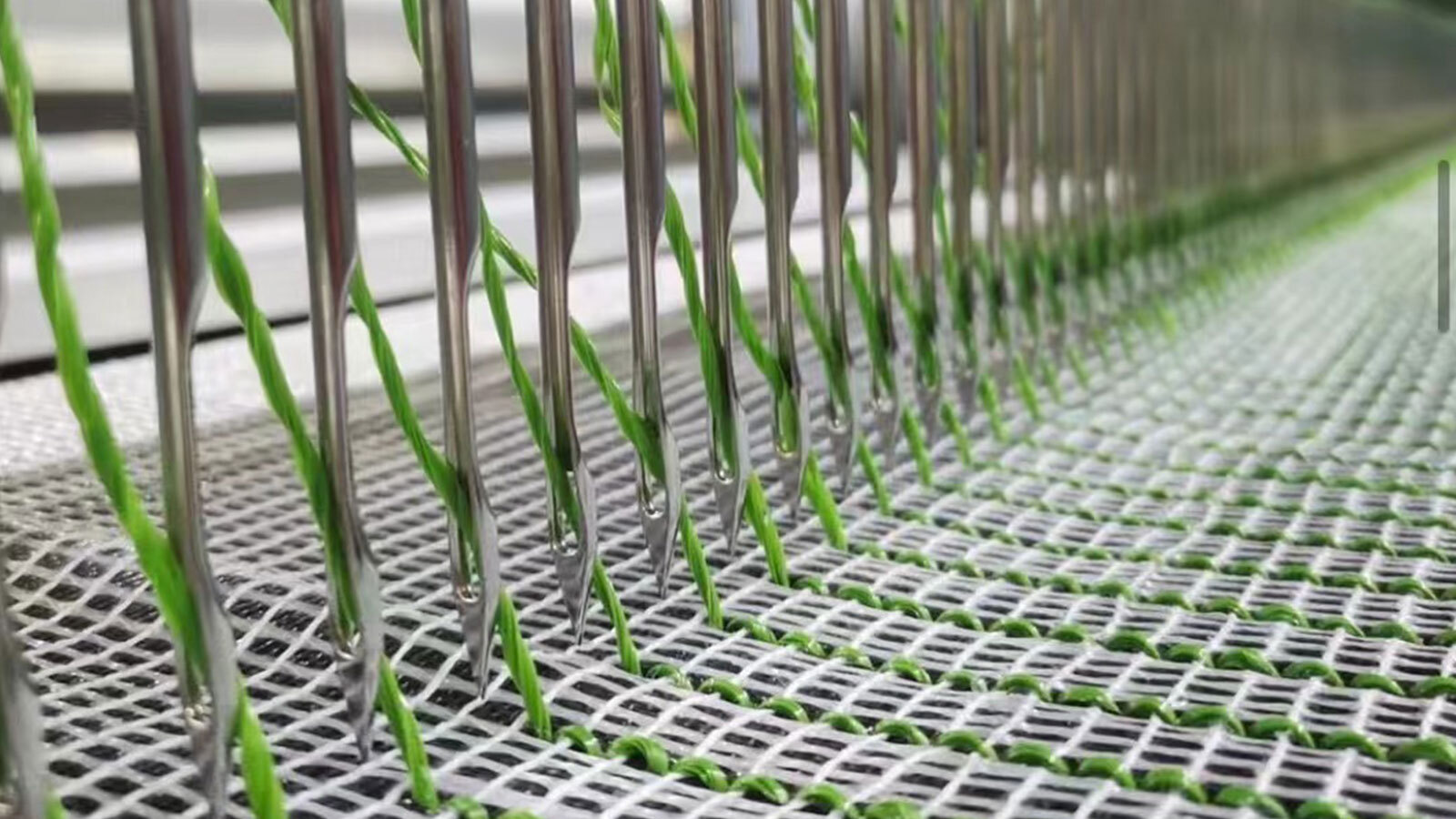 Artificial turf tufting process inserting green fibers into backing, forming durable synthetic grass structure for sports and landscaping use Artificial turf tufting process inserting green fibers into backing, forming durable synthetic grass structure for sports and landscaping use