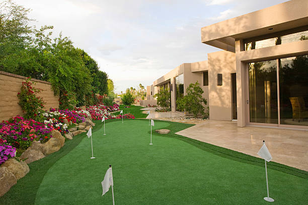 Luxury villa garden with premium artificial turf putting green, showcasing realistic synthetic grass for landscaping and sports use Luxury villa garden with premium artificial turf putting green, showcasing realistic synthetic grass for landscaping and sports use