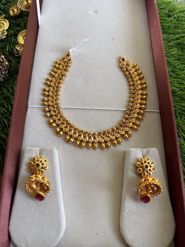 Traditional peacock design with unique stone neckpiece