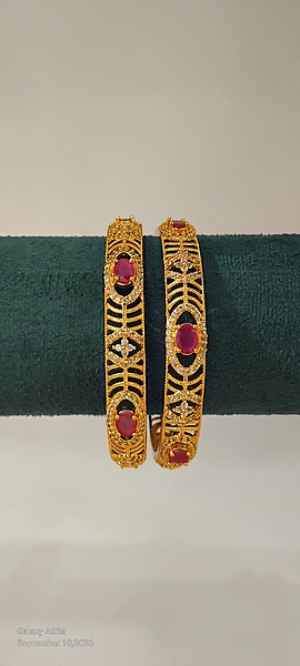 Gold plated oval shaped ruby red stone bangle