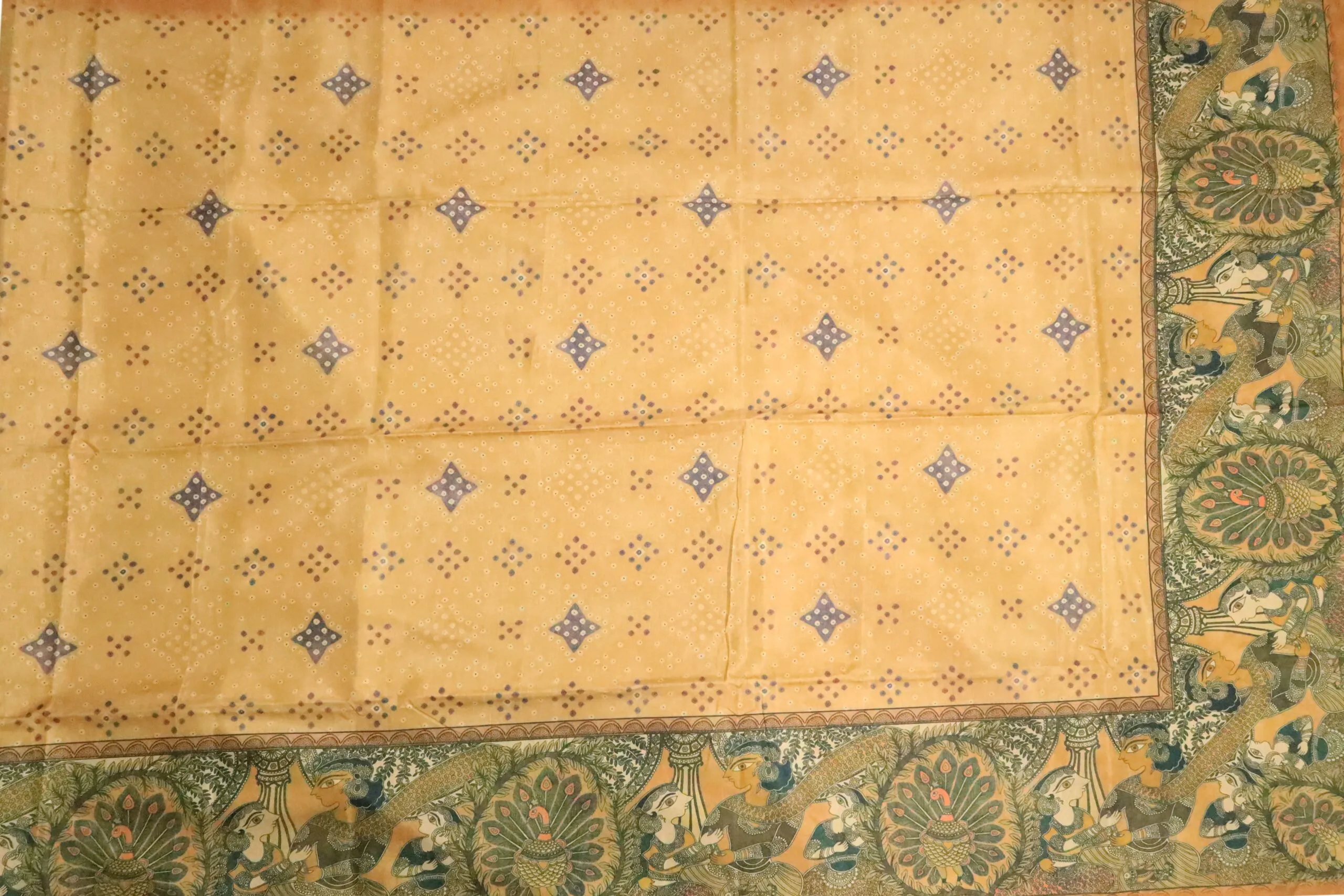 Semi Tussar – Mustard yellow, and a decorative peacock border