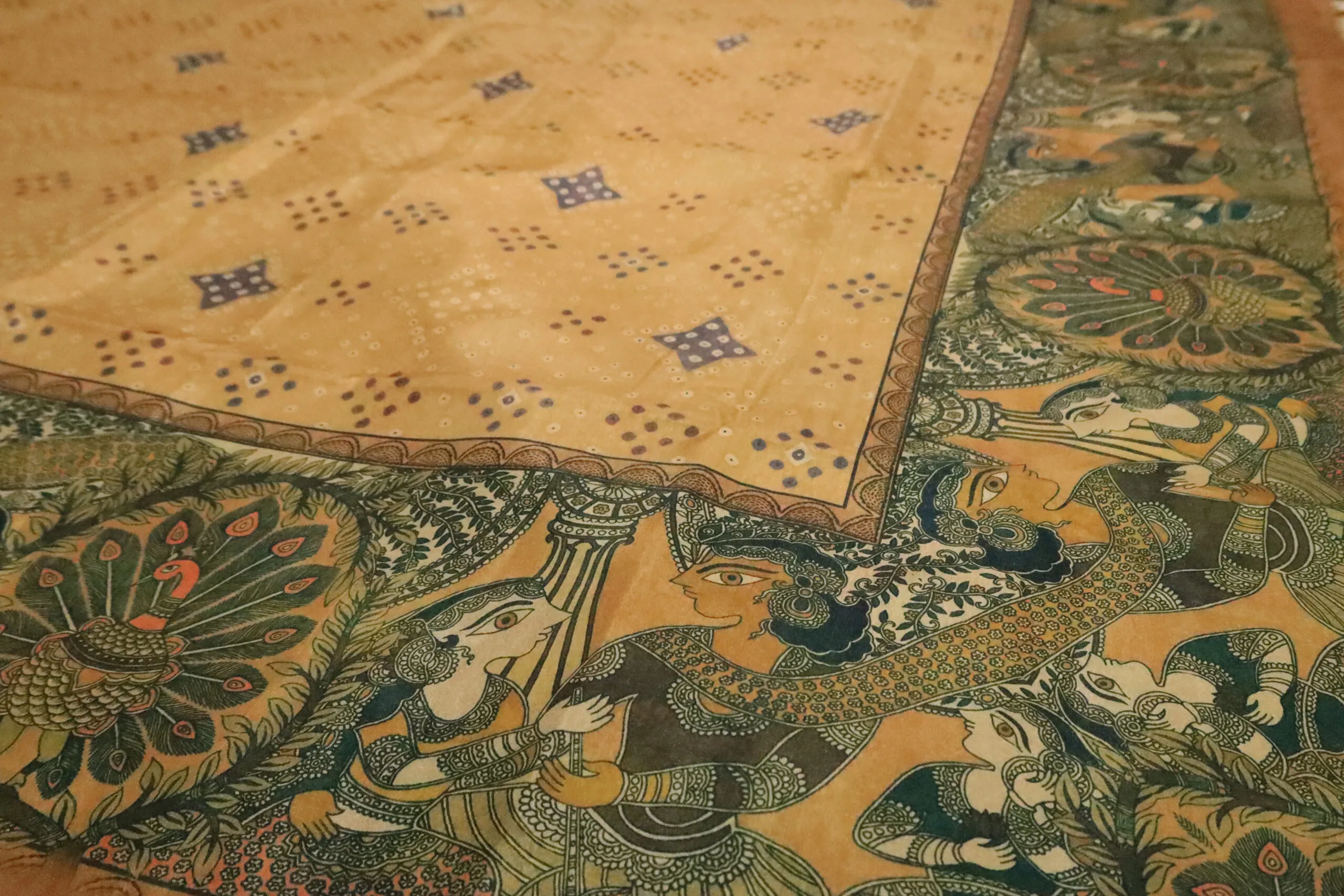 Semi Tussar – Mustard yellow, and a decorative peacock border