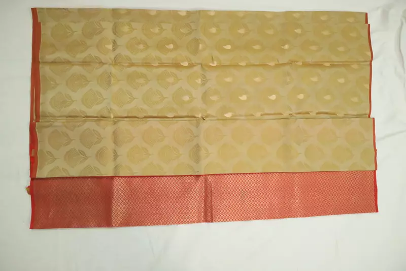 Golden beige silk saree with red zari border