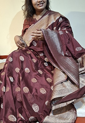 Elegant Maroon Khaddi Saree with Intricate Metallic Leaf Motifs & Rich Woven Border Elegant Maroon Khaddi Saree with Intricate Metallic Leaf Motifs & Rich Woven Border