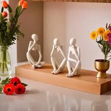 3 sitting statues