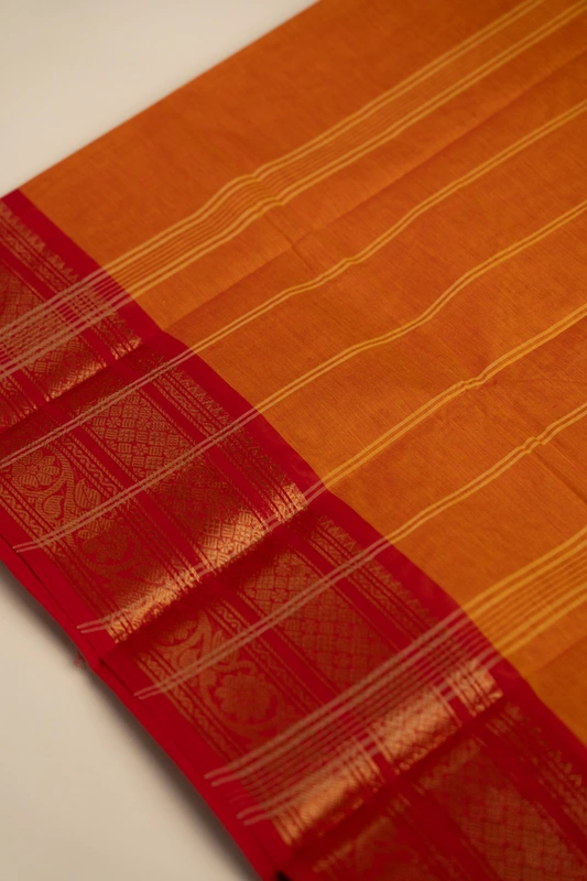 Kanchi Cotton plain body - Orange with Broad Red border