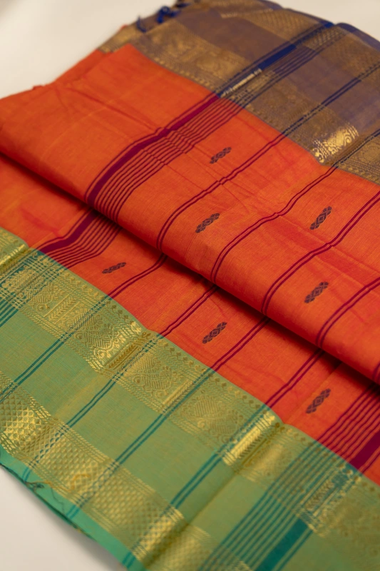 Kanchi Cotton body butta - Coral Orange Cotton Saree with Parrot Green Antique Gold Zari Bord