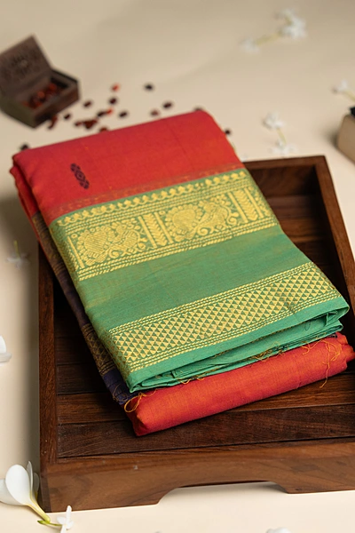 Kanchi Cotton body butta - Coral Orange Cotton Saree with Parrot Green Antique Gold Zari Bord