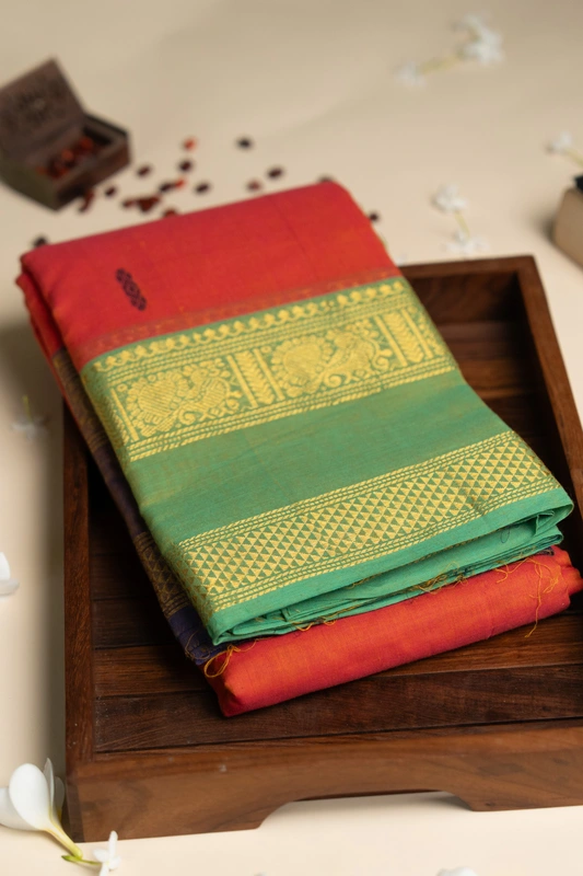Kanchi Cotton body butta - Coral Orange Cotton Saree with Parrot Green Antique Gold Zari Bord