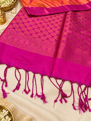 A beautiful blend of vibrant orange and rich magenta, adorned with exquisite golden zari motifs and an elegant traditional border