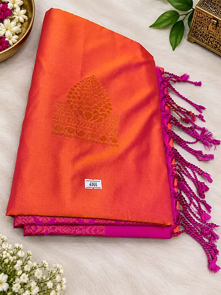 A beautiful blend of vibrant orange and rich magenta, adorned with exquisite golden zari motifs and an elegant traditional border