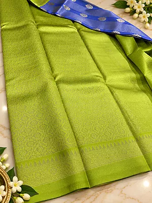 A beautiful Parrot Green Semi Soft Silk Saree featuring an elegant all-over hexagonal geometric jacquard pattern that gives the fabric a rich, textured appearance.