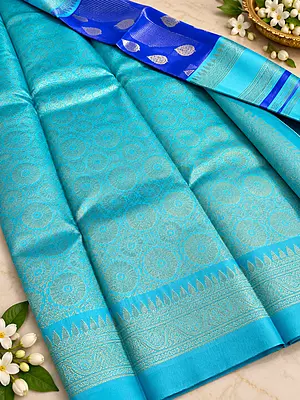 A gorgeous Turquoise Blue Semi Soft Silk Saree featuring an elegant all-over geometric jacquard weave that adds a subtle, luxurious texture to the fabric.