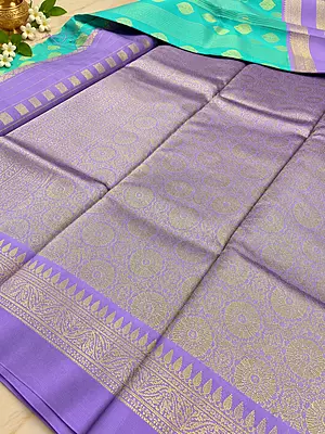 A graceful Lavender Purple Semi Soft Silk Saree featuring a delicate all-over geometric zari weave that creates a rich, textured look with a beautiful subtle sheen.