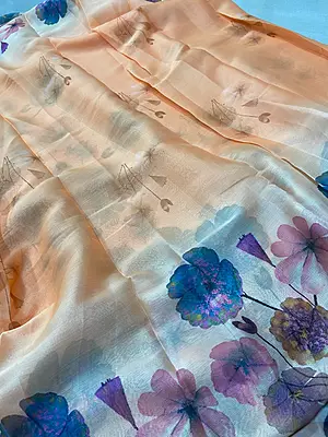 A dreamy peach saree adorned with vibrant watercolor-inspired florals in beautiful pastel and jewel tones — a perfect blend of elegance, freshness and effortless style?