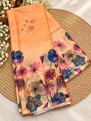A dreamy peach saree adorned with vibrant watercolor-inspired florals in beautiful pastel and jewel tones — a perfect blend of elegance, freshness and effortless style?