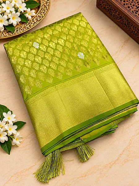 ? Lime Green Silk Saree – Description  Make a statement with this vibrant lime green silk saree, crafted with a luxurious sheen and intricate gold zari weaving