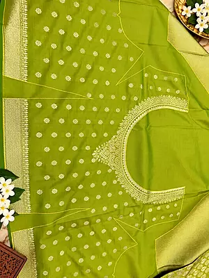 ? Lime Green Silk Saree – Description Make a statement with this vibrant lime green silk saree, crafted with a luxurious sheen and intricate gold zari weaving