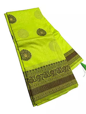 : This stunning light lime-green art silk saree is a perfect blend of traditional charm and contemporary style