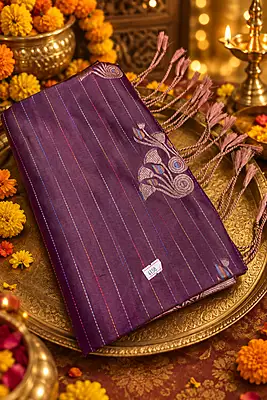 ?✨??✨? Royal Plum and Zari Elegance Description: * A rich plum-purple silk-blend saree featuring fine horizontal lines and scattered stylized silver-pink floral or peacock motifs across the body.