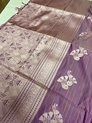 ?✨??✨? Royal Plum and Zari Elegance Description: * A rich plum-purple silk-blend saree featuring fine horizontal lines and scattered stylized silver-pink floral or peacock motifs across the body.