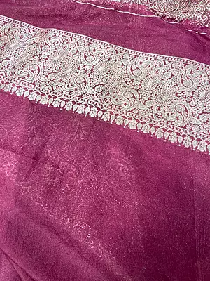 A deep maroon silk saree featuring scattered large, elegant silver-gold zari paisley motifs across the body