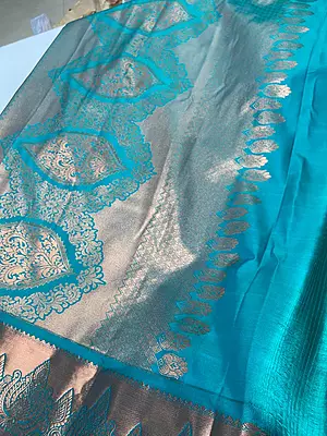 A radiant lime-green silk-blend saree featuring a rich all-over woven brocade vine design complemented by large, contrasting teal-blue and copper paisley motifs.