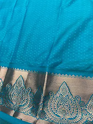 A radiant lime-green silk-blend saree featuring a rich all-over woven brocade vine design complemented by large, contrasting teal-blue and copper paisley motifs.