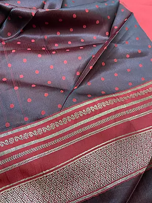 A rich and elegant deep maroon silk saree featuring beautiful traditional zari detailing. The saree is enhanced with fine golden striped borders