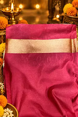 ? Pink Silk Saree – Description A vibrant bright pink silk saree featuring elegant traditional gold zari motifs.