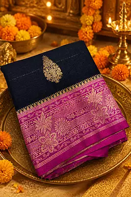 A striking navy blue silk saree beautifully accented with a vibrant magenta-pink pallu and border.