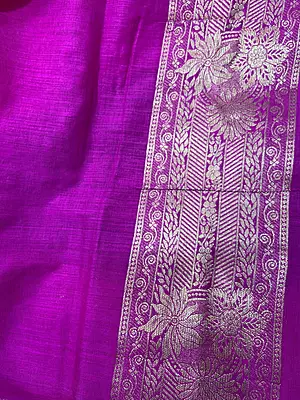 A striking navy blue silk saree beautifully accented with a vibrant magenta-pink pallu and border.