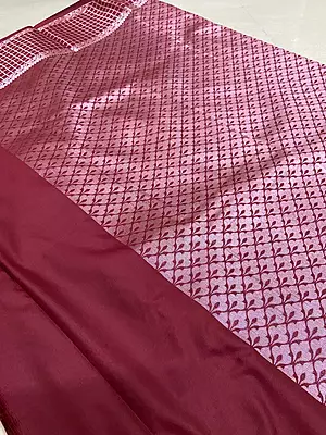 A graceful cream silk saree featuring delicate mauve-toned floral buttas scattered across the body.