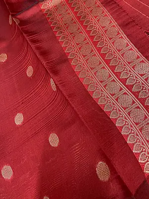 A striking navy blue and vibrant red silk saree featuring elegant gold zari polka buttas across the deep navy body