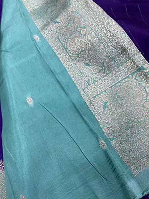 A gorgeous royal purple silk saree featuring delicate gold zari paisley buttas beautifully scattered across the body.