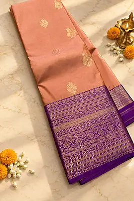 ? Peach & Purple Silk Saree – Description A graceful peach silk saree featuring delicate gold zari floral buttas scattered elegantly across the body.