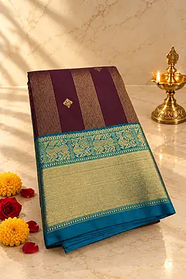 A rich deep wine silk saree featuring elegant vertical gold zari stripe detailing
