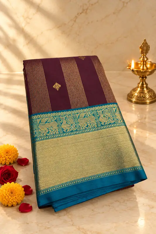 A rich deep wine silk saree featuring elegant vertical gold zari stripe detailing