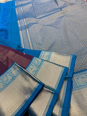 A rich deep wine silk saree featuring elegant vertical gold zari stripe detailing