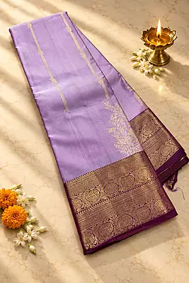A graceful lavender silk saree with an elegant wine contrast border
