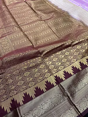 A graceful lavender silk saree with an elegant wine contrast border