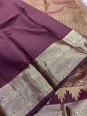 A graceful lavender silk saree with an elegant wine contrast border