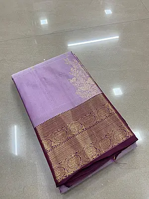 A graceful lavender silk saree with an elegant wine contrast border