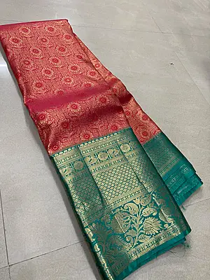 A rich red and teal silk saree featuring an intricate all-over gold zari floral pattern on the body.