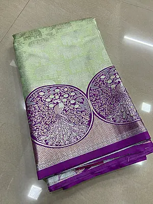 A beautiful pastel green silk saree featuring delicate silver zari elephant motifs across the body.