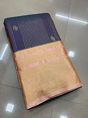 A sophisticated deep navy blue silk saree adorned with fine gold zari checks and traditional motifs.